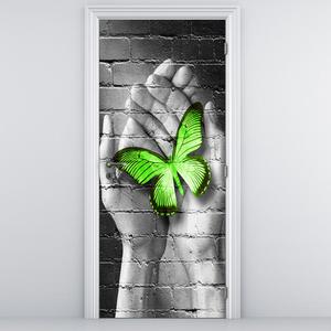 Fotótapéta ajtóra - Zöld pillangó a tenyérben